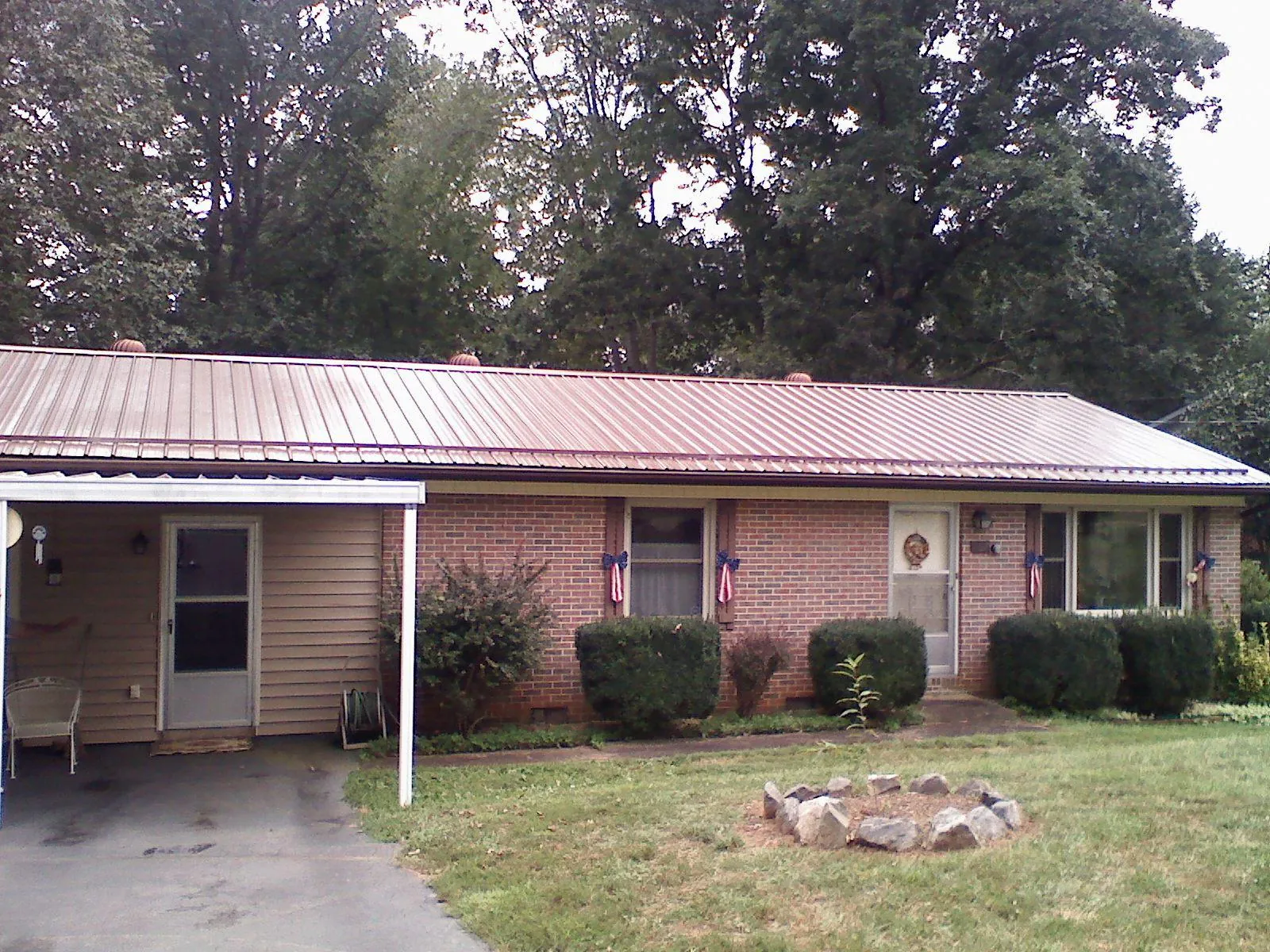Bronze metal roof and carport on a brick ranch home — Roof Repair work by our crew in Jacksonboro
